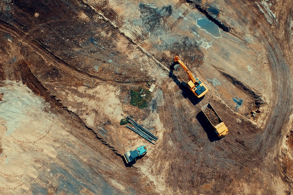 Aerial view of a construction site with excavators and heavy machinery, showing typical orthomosaic mapping subject