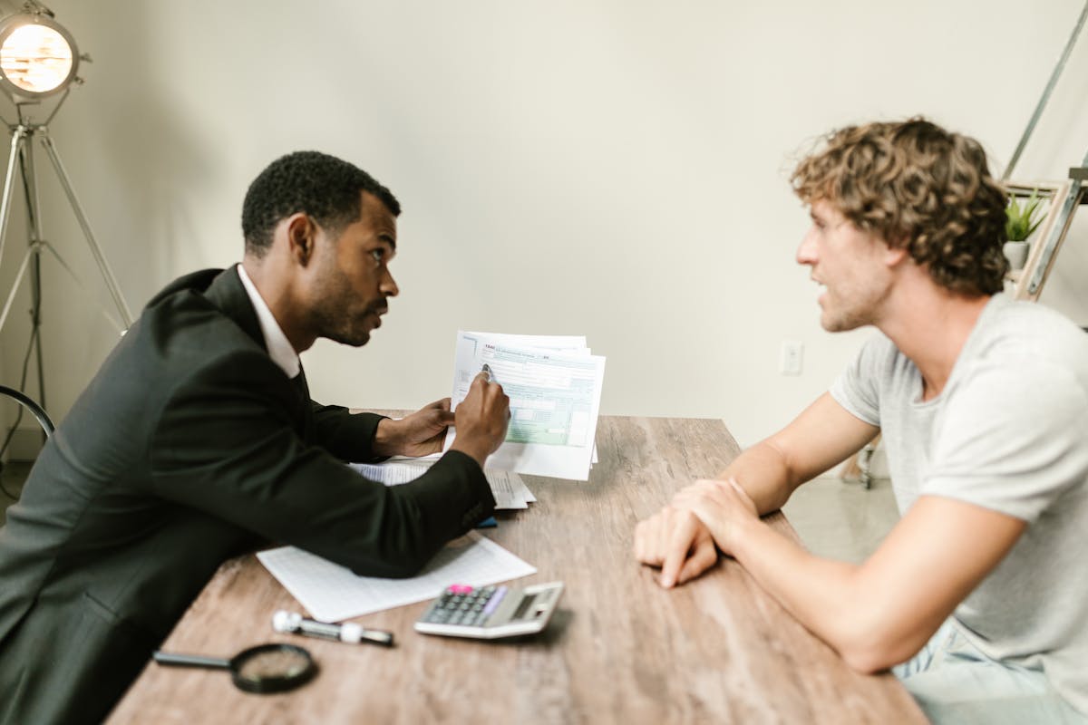 Professional reviewing documents and forms at an office desk