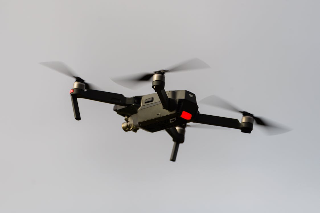 Professional black quadcopter drone in flight, representative of enterprise survey drones