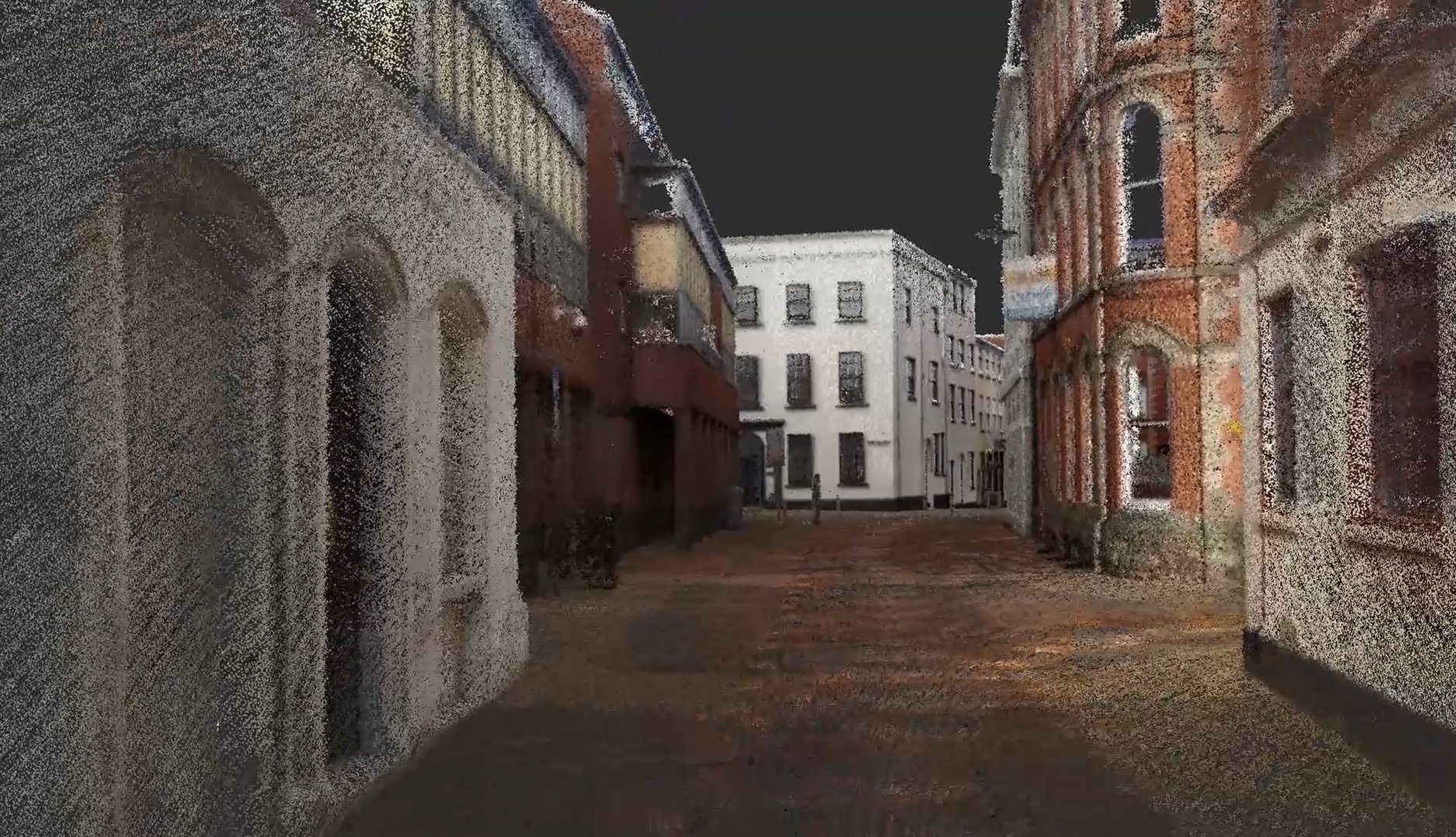 Colorized 3D point cloud visualization of historic buildings on a street showing millions of individual scan points