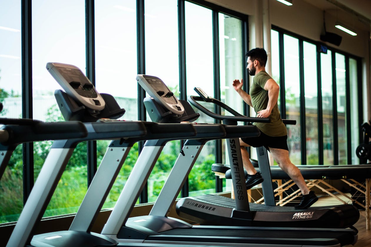 Modern fitness center with treadmills and floor-to-ceiling windows — gyms and fitness centers benefit from virtual tours that showcase equipment and facilities