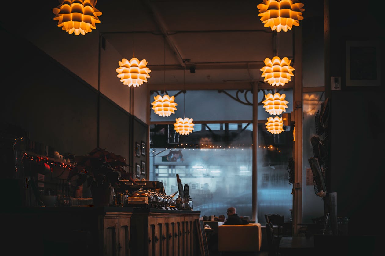 Warm ambient restaurant interior with decorative pendant lights and a cozy atmosphere — the type of business that benefits most from Google Business Profile virtual tours