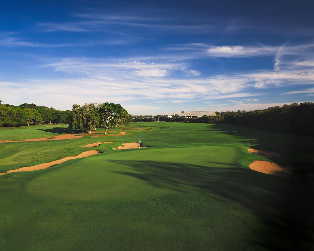 Aerial view of a golf course showing manicured greens, bunkers, and tree canopy — the terrain LiDAR mapping captures