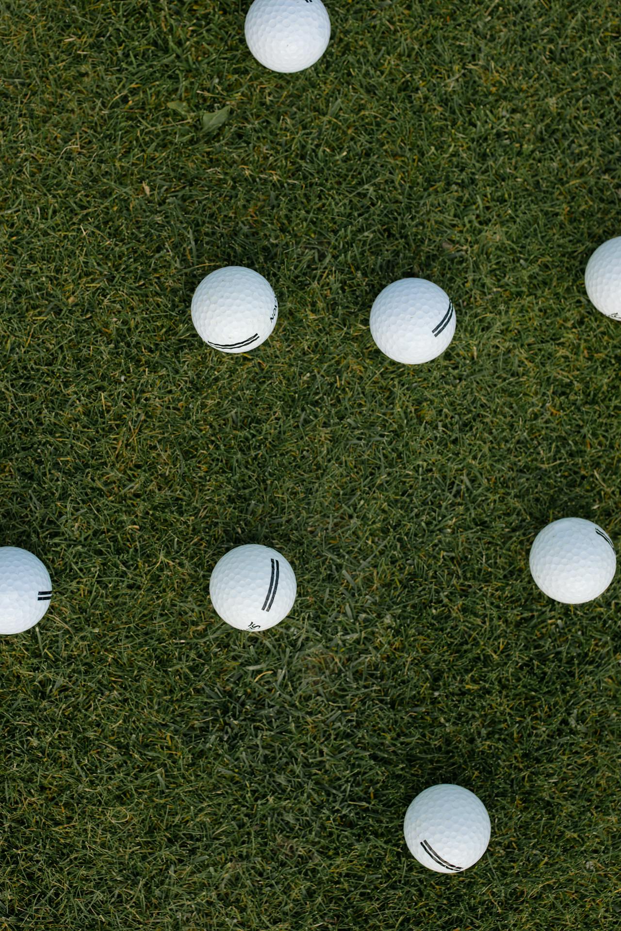 Golf balls on a manicured green — maintaining these surfaces requires precise drainage that LiDAR surveys reveal