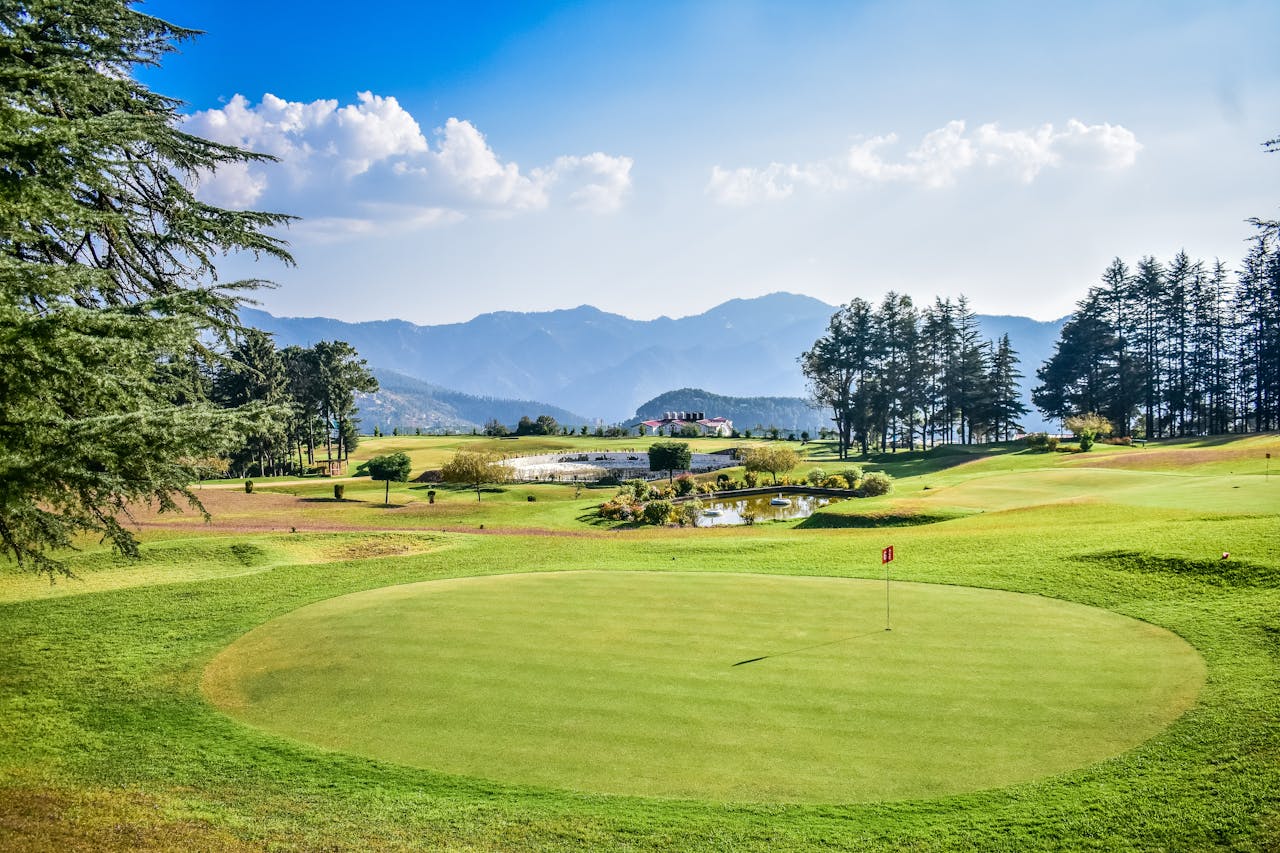 Golf course green with mountains in background — water management is one of the biggest cost centers for course operators