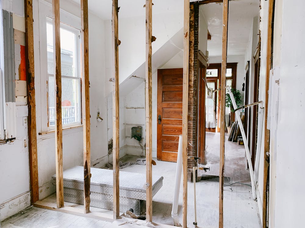 House renovation interior showing walls and floors being prepared for measurement