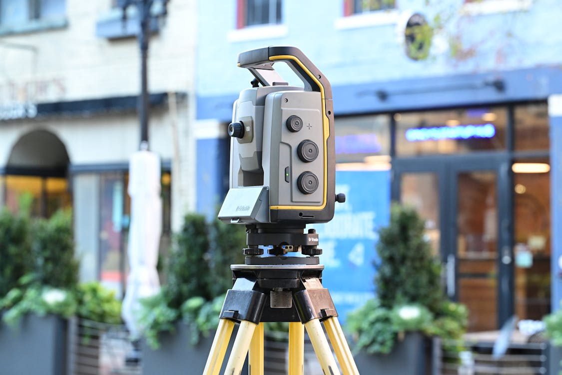 Land surveying equipment being used in an outdoor field setting