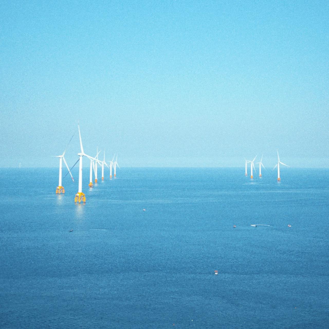 Offshore wind farm turbines that benefit from rapid dock-based drone response