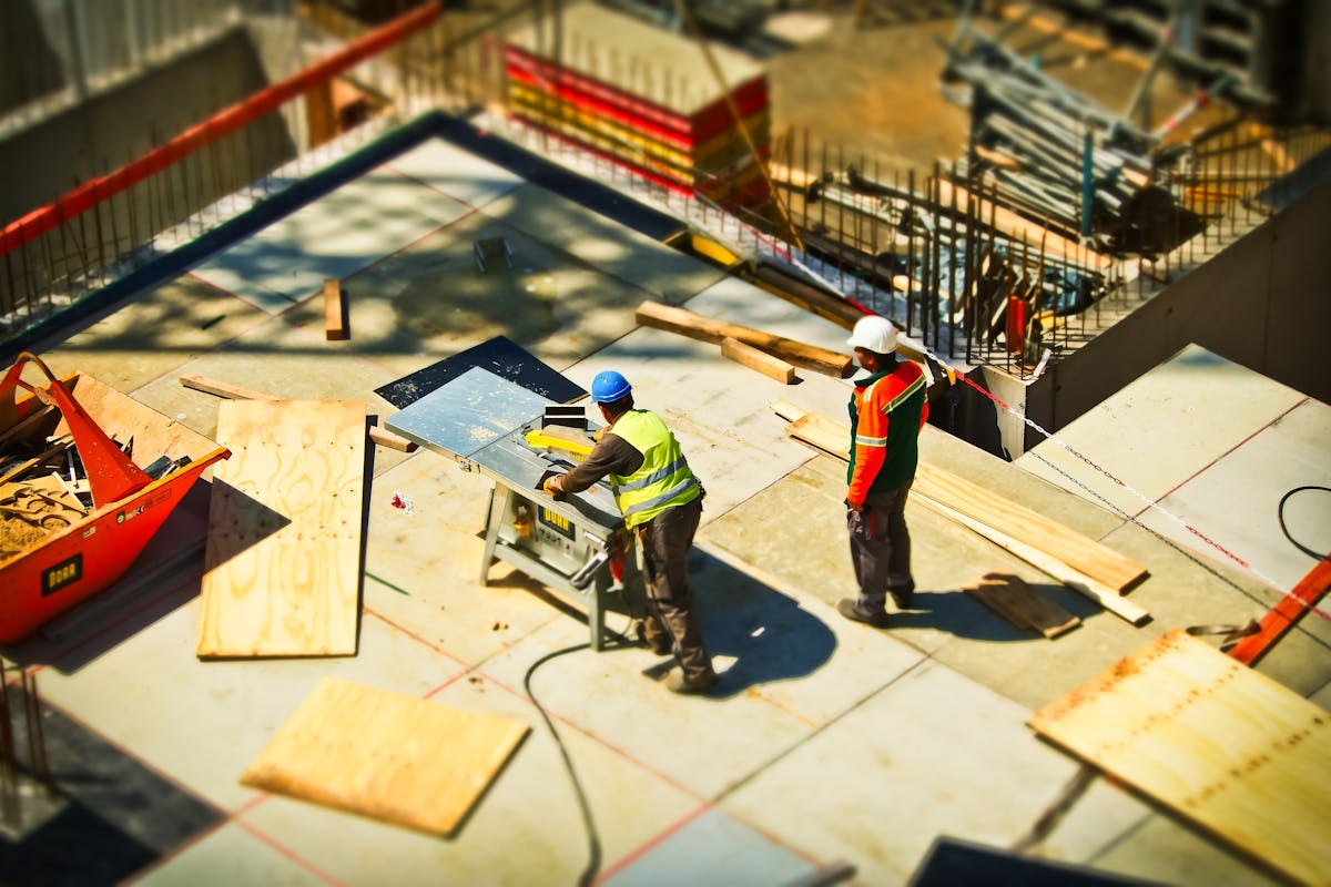Construction site with workers reviewing plans on a commercial building project