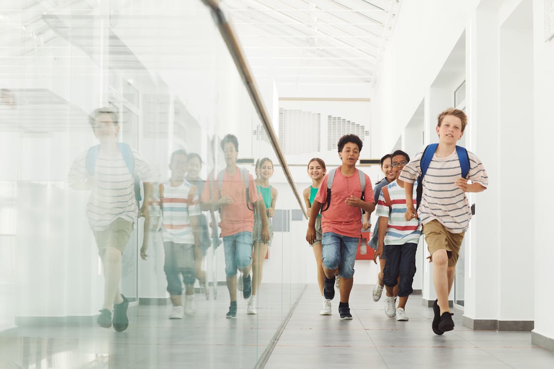 Students walking through a bright modern school hallway