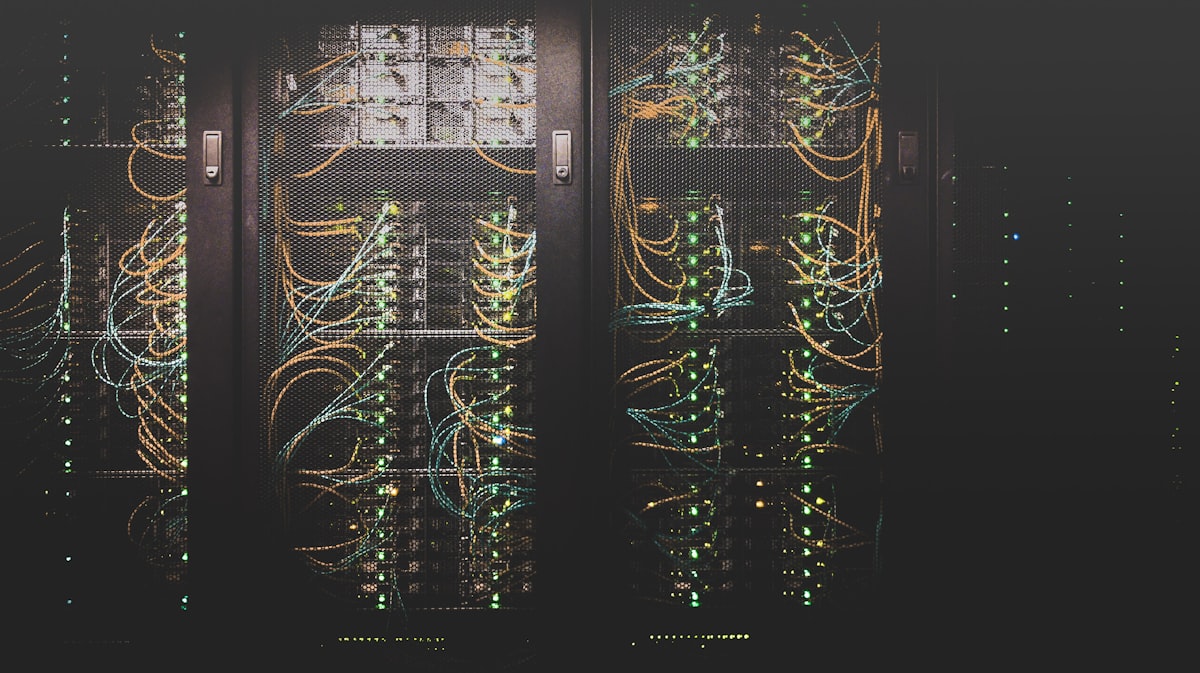 Server room with illuminated network cables and server racks representing self-hosting infrastructure for virtual tours