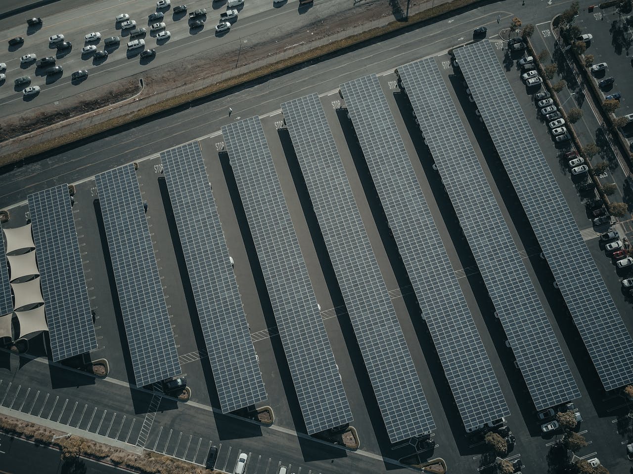 Aerial view of rows of solar panels at a large-scale solar farm — drone thermal inspection covers these installations at 50-100 MW per day
