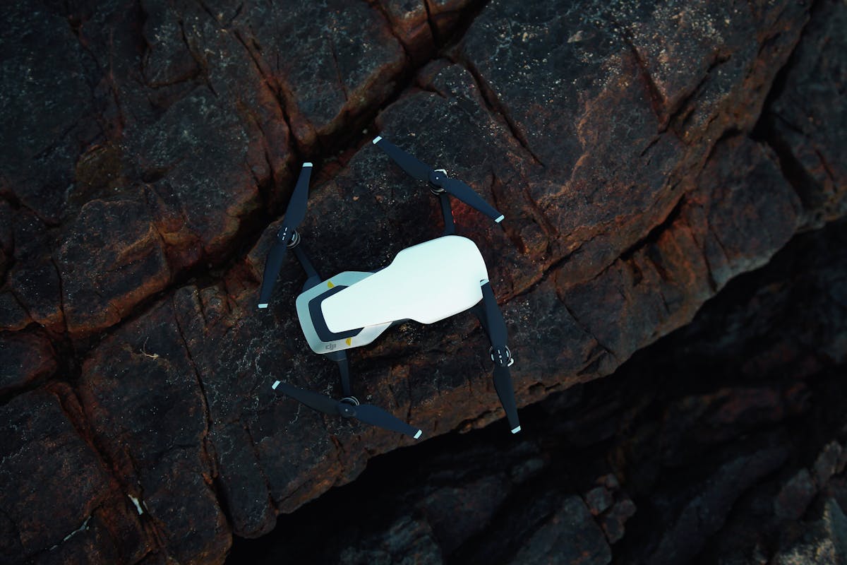 DJI drone resting on dark rocky terrain, ready for an aerial mapping or survey mission