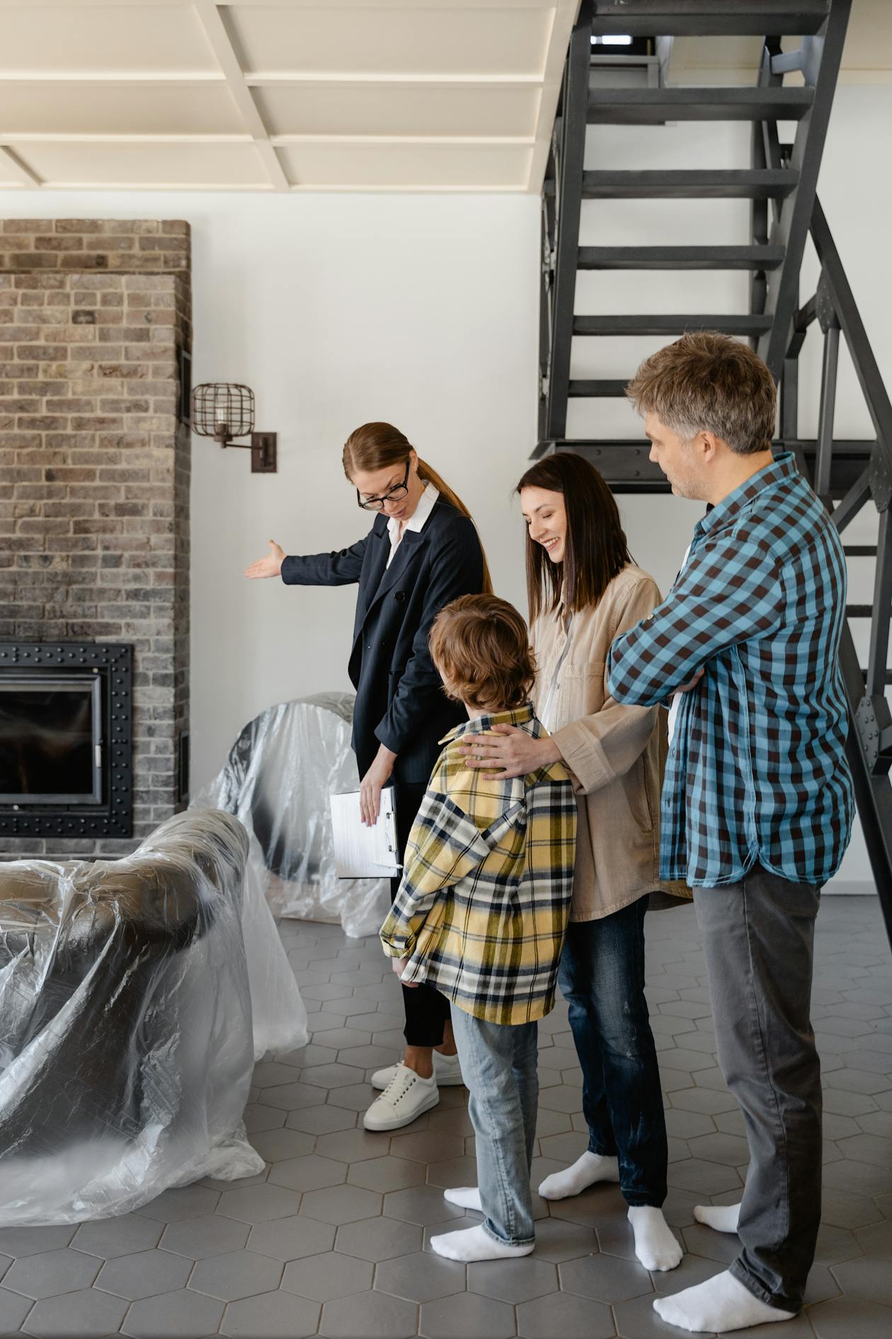 Real estate agent showing a property to a family during a house tour